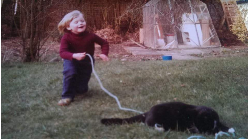 Child Playing safely with cat